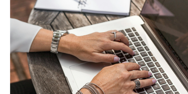 Someone typing on a laptop computer.