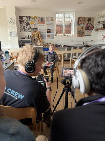Child being filmed in a classroom.