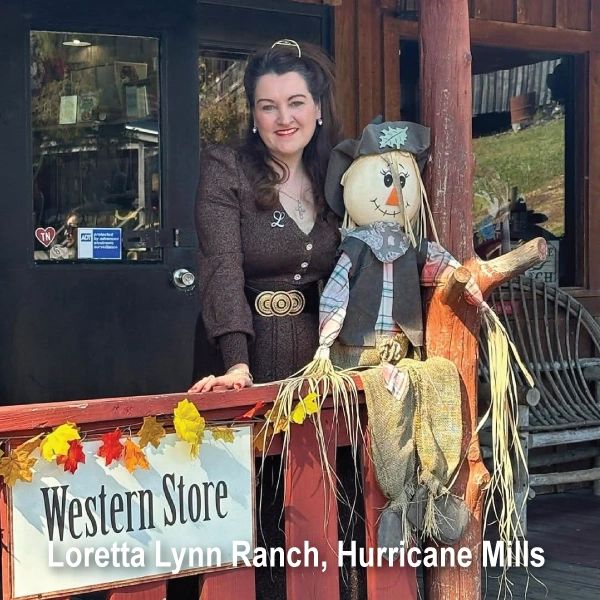 A woman stands beside a scarecrow at Western Store in Loretta Lynn Ranch.