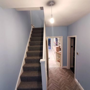 hallway and stairs with duck egg blue colour , with white glossed woodwork