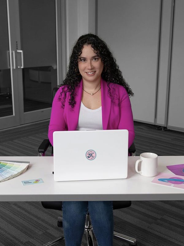 Female graphic designer using laptop during branding and logo project in Pensacola Florida studio