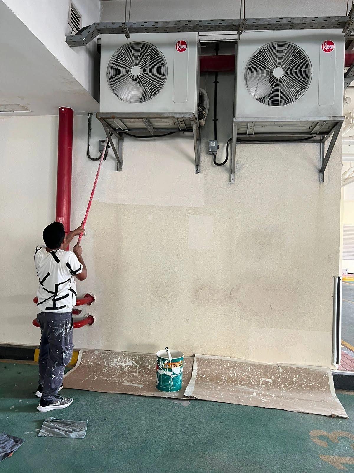 Wall painting at the parking ground floor after repairing all damaged walls