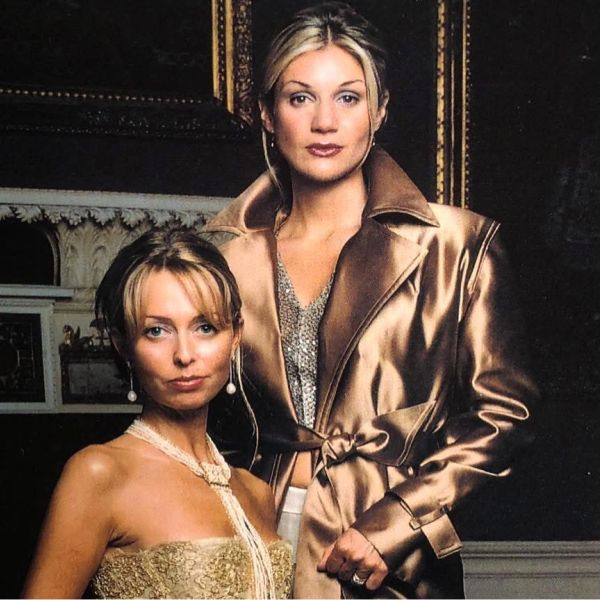 Two elegant women posing together, dressed in glamorous evening attire.