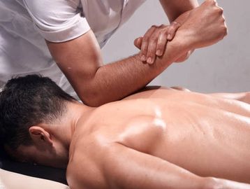a man giving a massage with his elbow