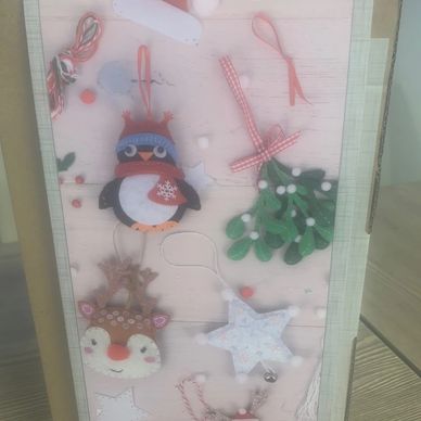 Christmas-themed felt ornaments including a penguin, reindeer, star, and mistletoe.
