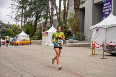 Runner smiling during an outdoor race event.