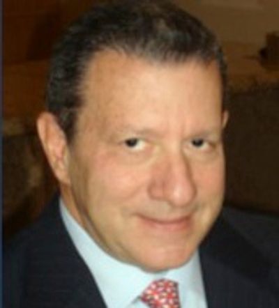 Portrait of a middle-aged man in a suit and tie.