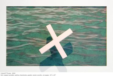 A white geometric cross sculpture stands against a textured green background.