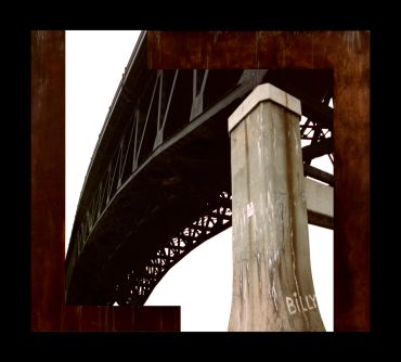 Close-up view of a concrete pillar supporting a large steel bridge.