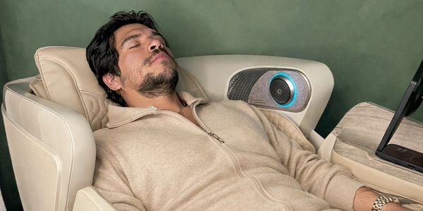Man relaxing in a reclining seat with eyes closed.