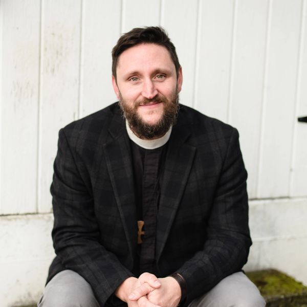 Photo of Fr. Aaron Burt, podcast host and rector of Advent Anglican church sitting outdoors.