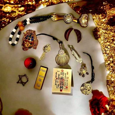 A collection of ornate, traditional Asian artifacts and jewelry displayed on a surface.