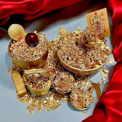 A display of golden treasures and ornaments on a satin fabric.