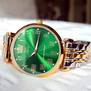 Gold watch with a green watch dial