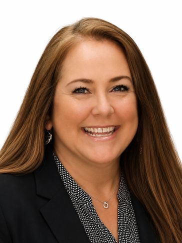 Smiling woman with long brown hair in professional attire.