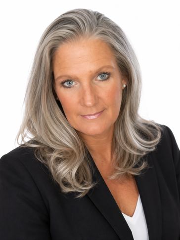 Professional woman with gray hair wearing a black blazer.