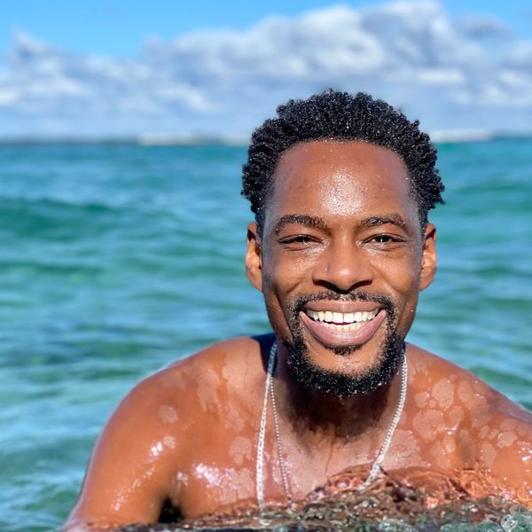 Smiling man enjoying a sunny day in the ocean water.