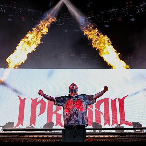 Performer with fiery pyrotechnics on stage. 