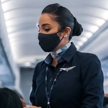 Flight attendant assisting customer