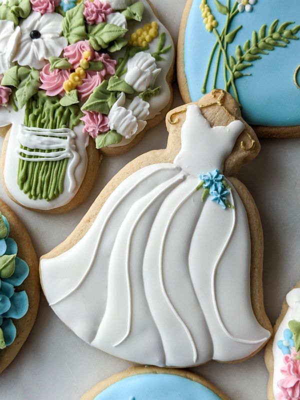 Bridal shower cookies including a gown, ring, bouquet, and hydrangeas