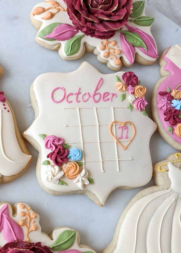 Calendar sugar cookie with the date October 11th with a heart surrounding the 11