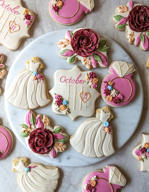 Bridal shower wedding sugar cookies with florals, gowns, rings, and calendars