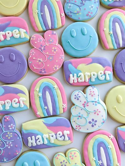 Sugar cookies with a "Groovy" theme, with smiley faces, rainbows, and peace signs