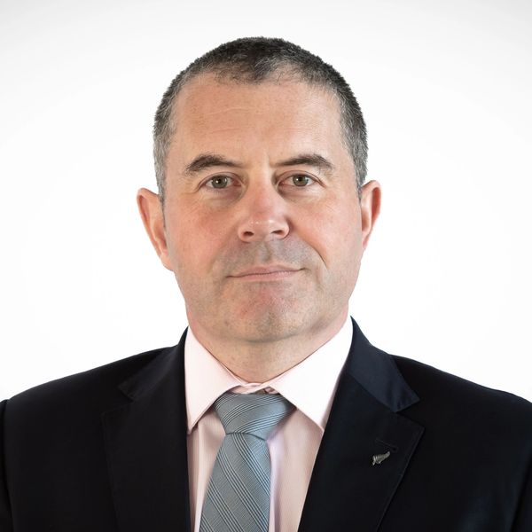 Professional man in suit and tie against white background.
