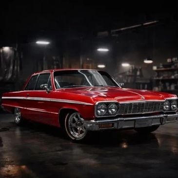 Shiny red classic car in a dimly lit garage.