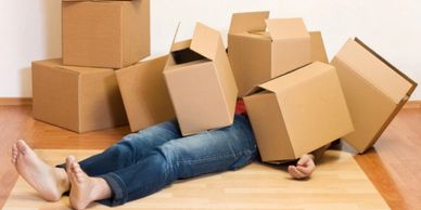 Moving is stressful. Person struggling with moving boxes
