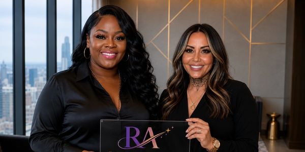 Two women holding a Radiant Align Talent Group sign and smiling.