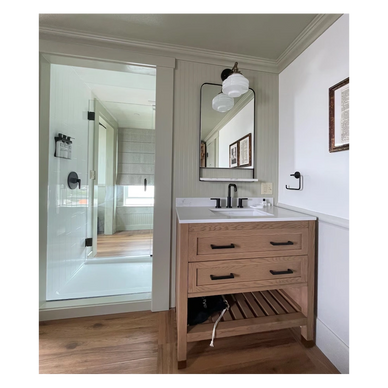 Boutique hotel bathroom in Newport, OR, featuring tile upgrades and fixtures renovated by Proside Co