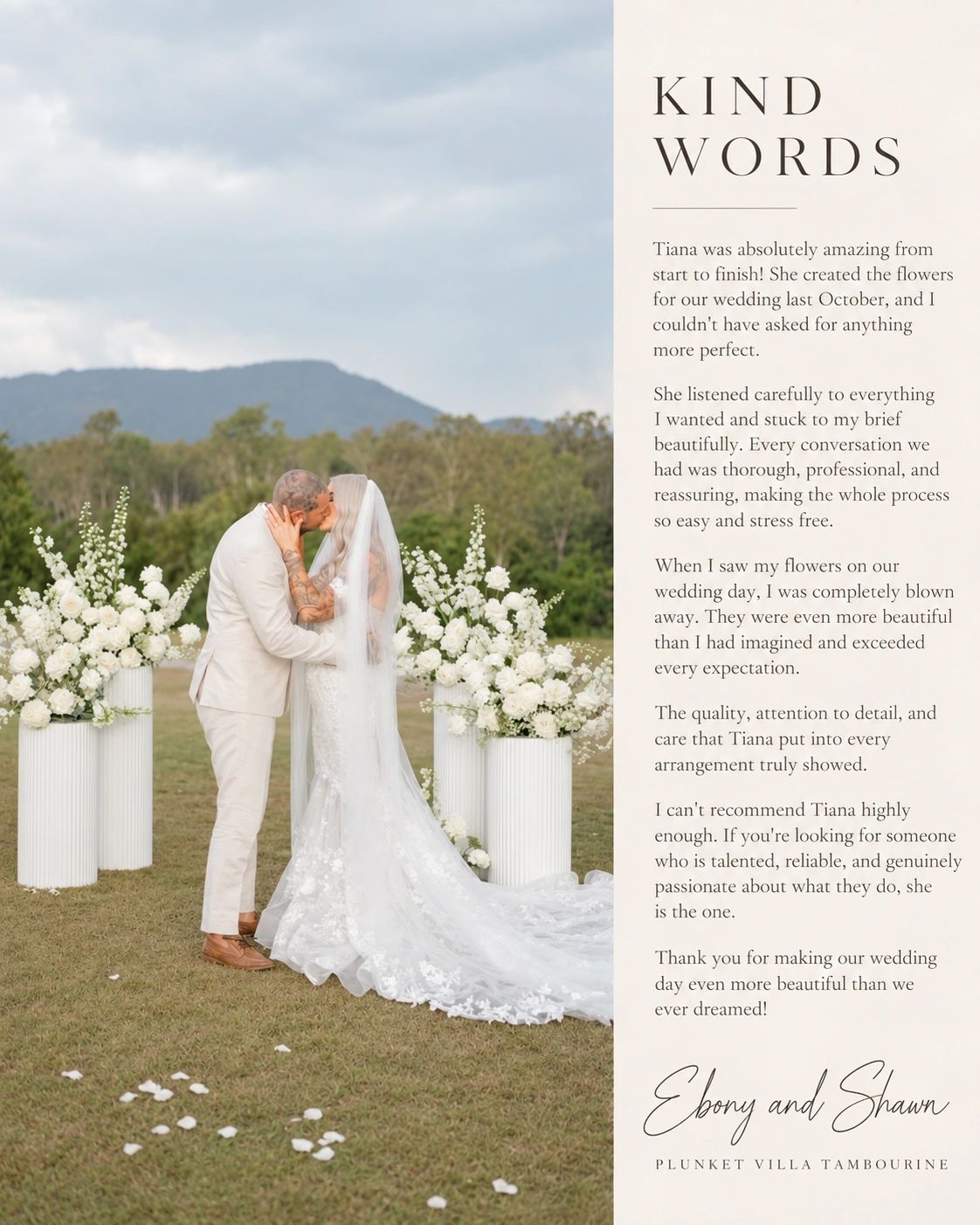 Bride and groom kissing outdoors surrounded by white flowers.