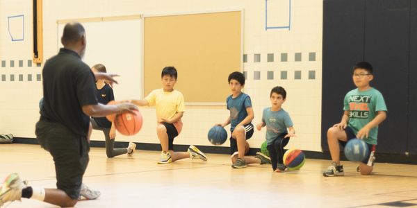 Instructor teaching basketball