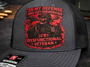 Black cap with red skeleton veteran design and humorous text.
