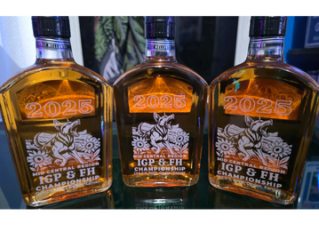 Three 2025 IGP &amp; FH Championship whiskey bottles displayed side by side.