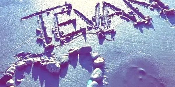 His name carved on a sandy beach in California.