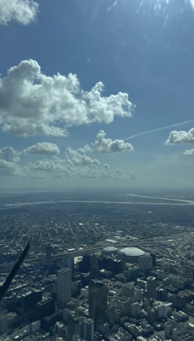 Aerial view of a city with a blue sky and clouds.