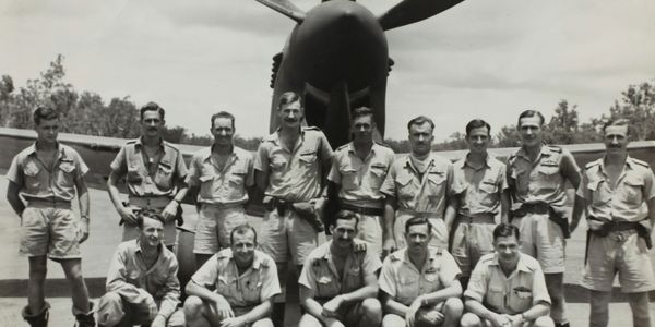 Military men in front of plane, image courtesy of Museums Victoria, via Unsplash