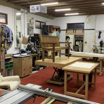 A woodworking workshop with a wooden bench on a table.