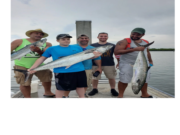 clients holding kingfish caught offshore fishing