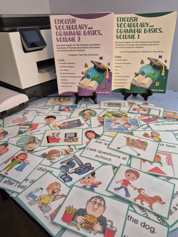 Two English vocabulary and grammar books with illustrated flashcards.