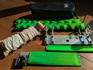 Sling training kit components on a wooden surface.