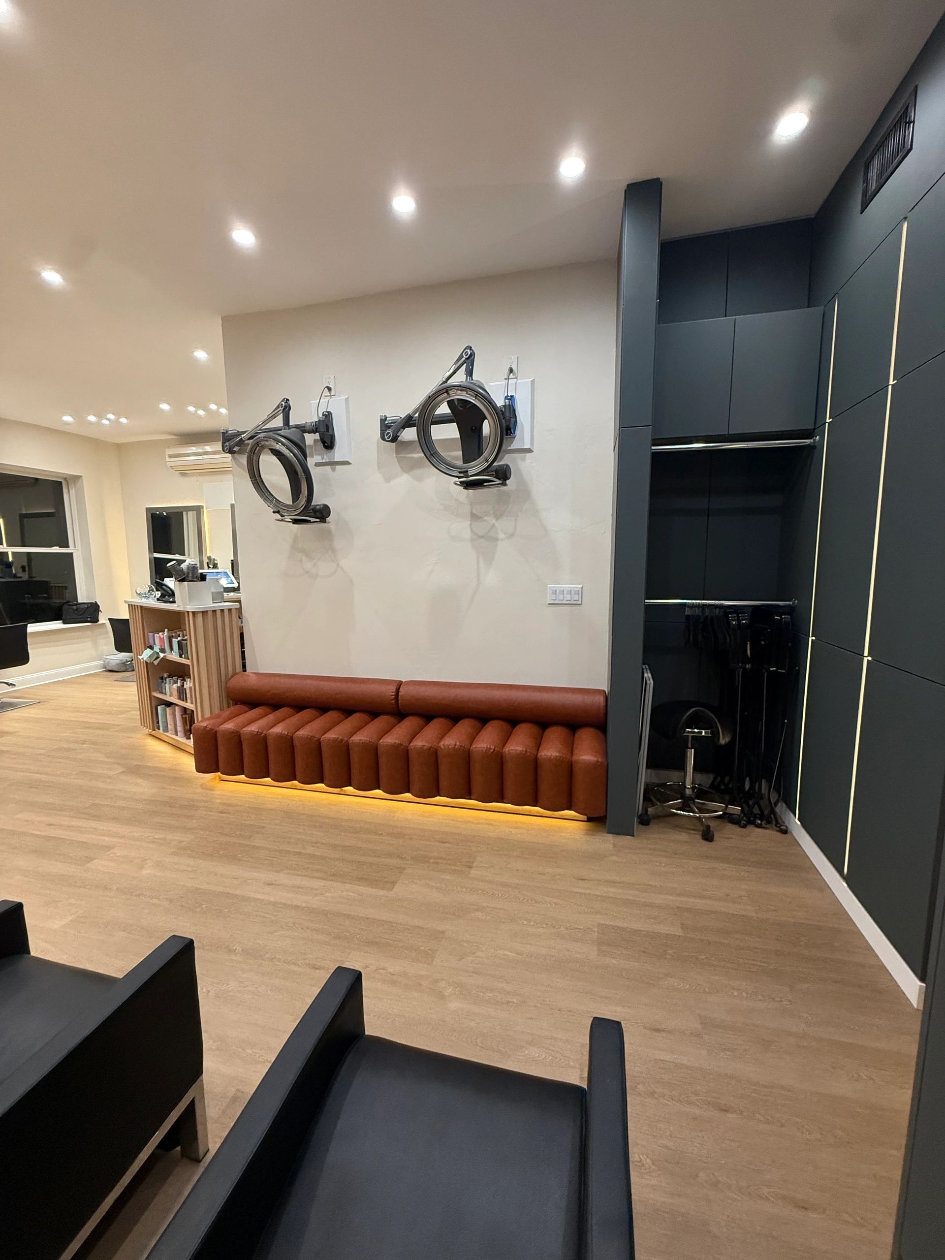 Modern salon interior with sleek lighting and seating arrangements.