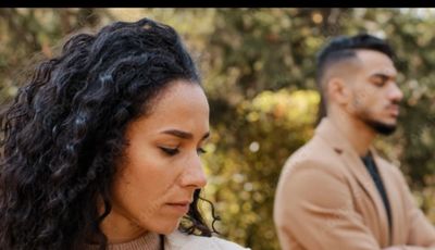 Couple facing away, looking upset as they face a choice between being right or helping their partner feel safe to express themselves 