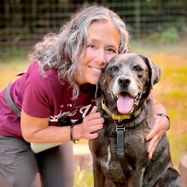 Woman gently hugging her dog