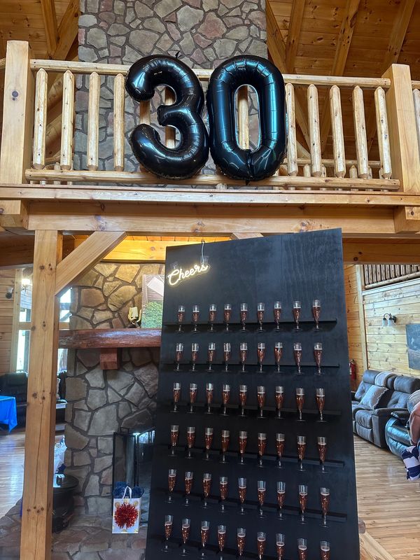 specialty balloons and champagne wall at a 30th business anniversary celebration