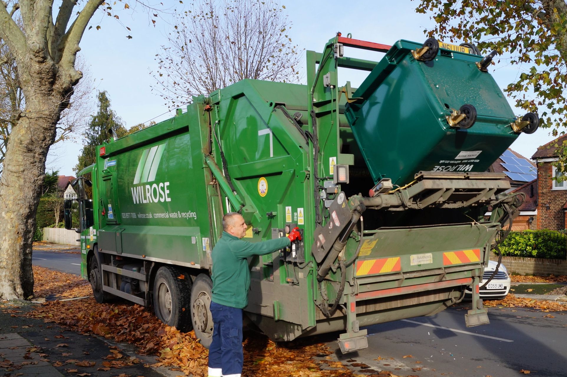 Wilrose commercial waste dustcart tipping a wheelie bin and driver