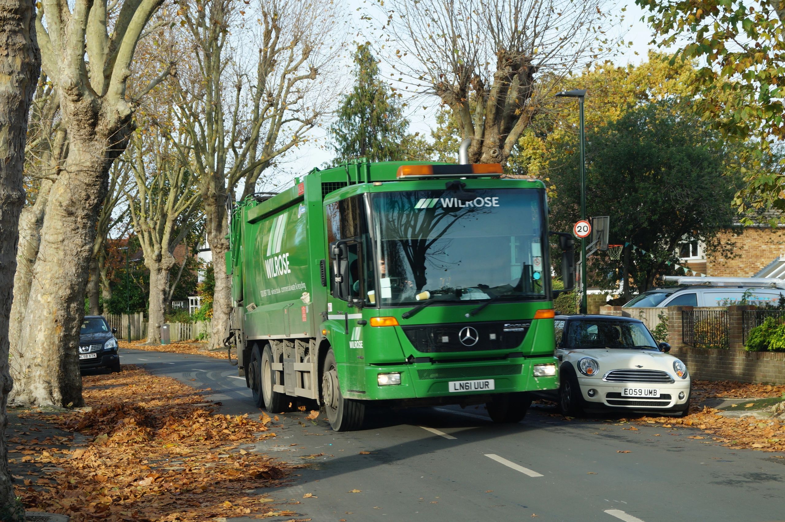 Wilrose dustcart in reigate driving down the road with commercial waste on it.