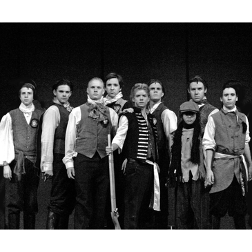 Black and white photo of young actors in historical costumes.